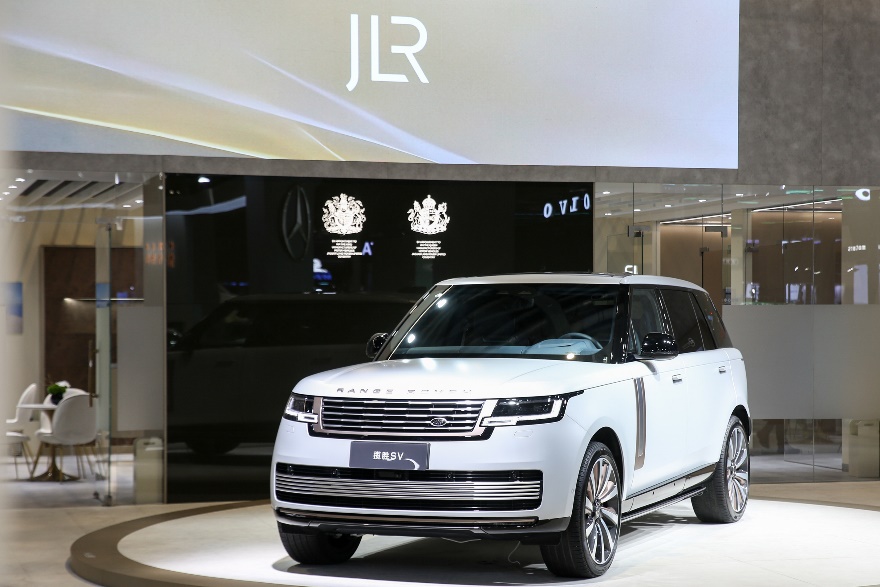 A white car in a showroomDescription automatically generated