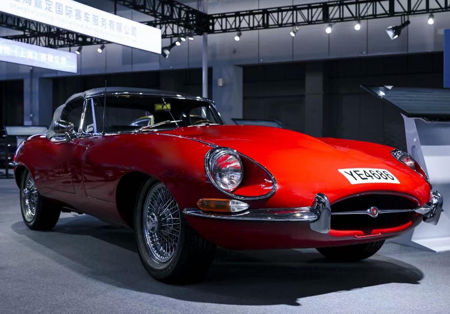 A red car parked in a roomDescription automatically generated